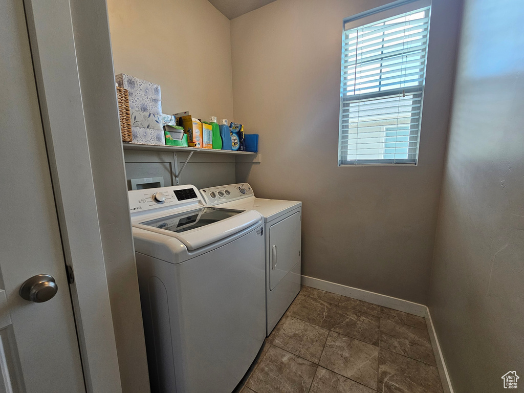 Laundry area with laundry area, washing machine and dryer, and baseboards