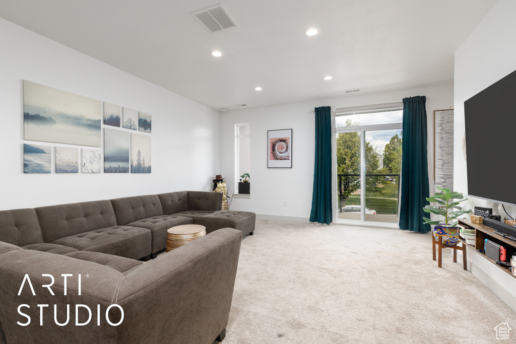 Carpeted living area featuring visible vents, recessed lighting, and baseboards