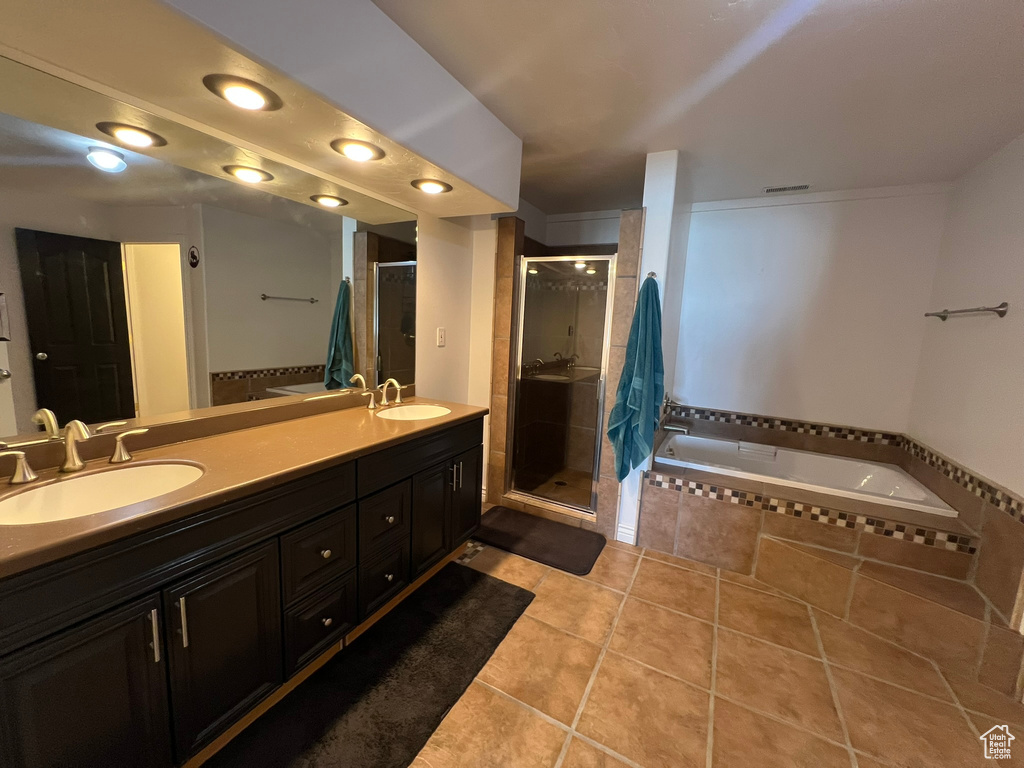 Bathroom with a bath, double vanity, a sink, and a shower stall