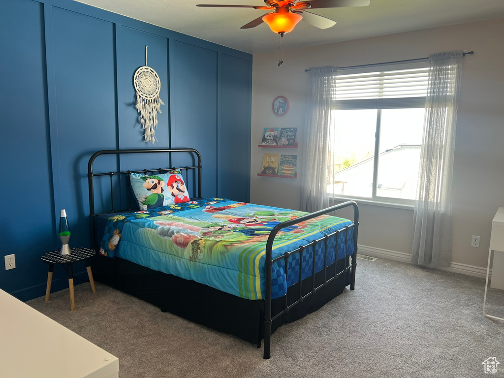 Bedroom with baseboards, ceiling fan, and carpet flooring