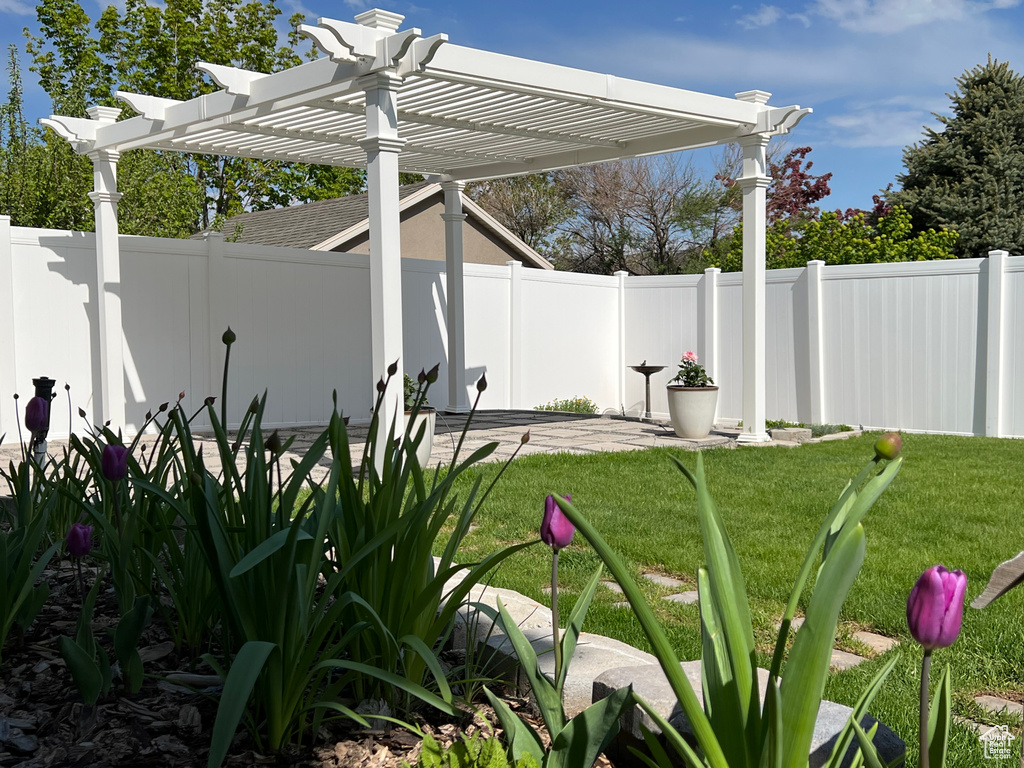 View of yard featuring a fenced backyard and a pergola