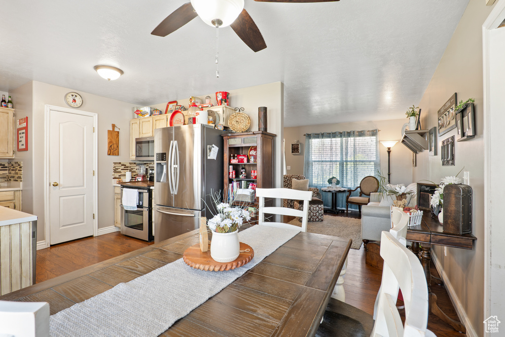 Dining area with a ceiling fan, wood finished floors, and baseboards