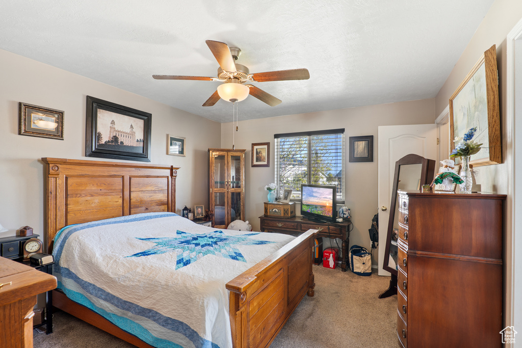 Bedroom featuring ceiling fan and light colored carpet