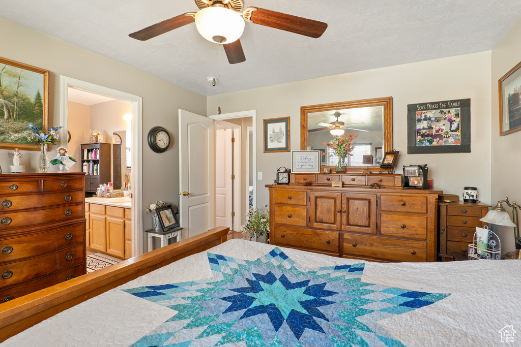 Bedroom with ceiling fan and ensuite bathroom