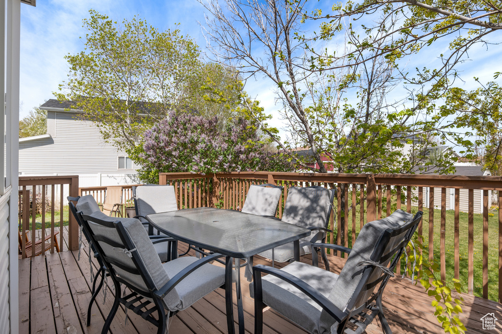 Wooden deck featuring outdoor dining area