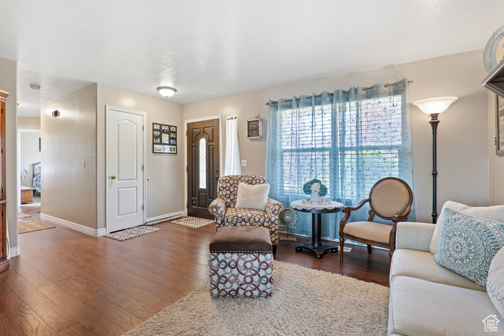 Living room with dark wood finished floors and baseboards