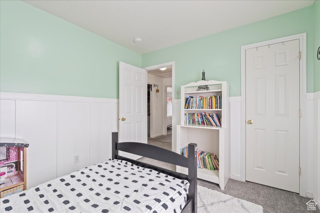 Carpeted bedroom with wainscoting