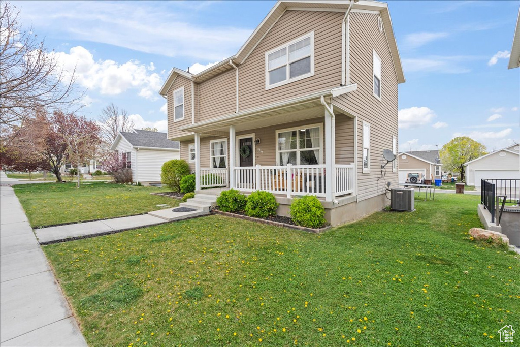Traditional home featuring central AC, a porch, and a front lawn