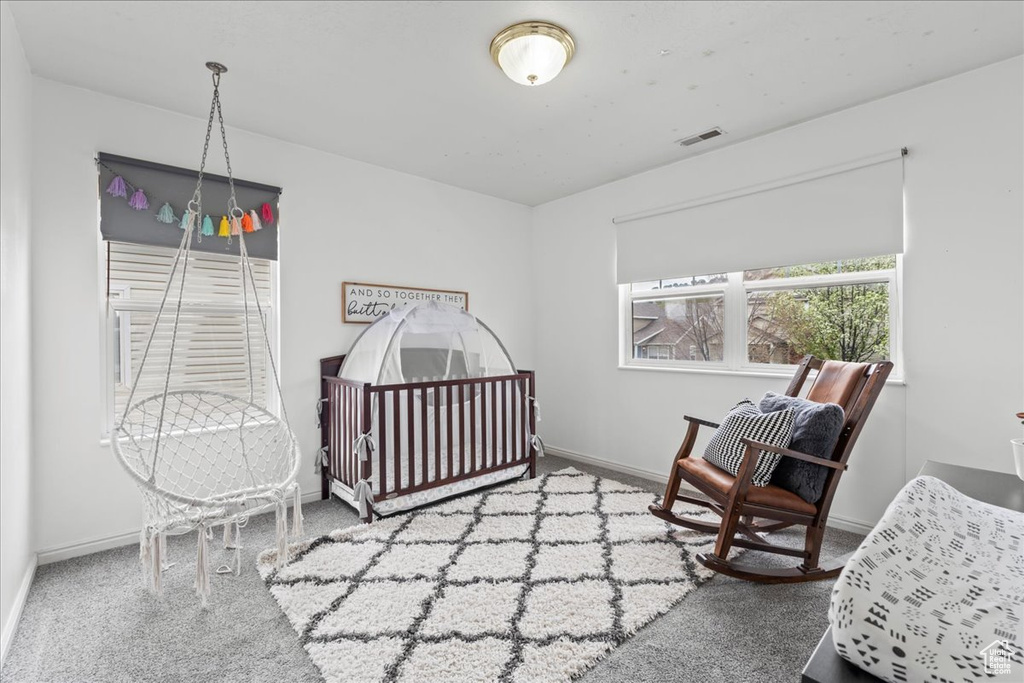 Carpeted bedroom with visible vents and baseboards