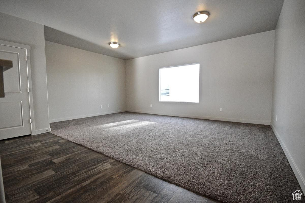 Spare room featuring baseboards and wood finished floors