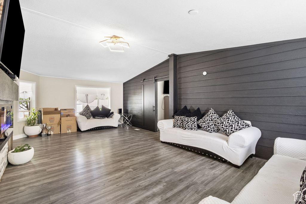 Living area featuring wood finished floors and vaulted ceiling