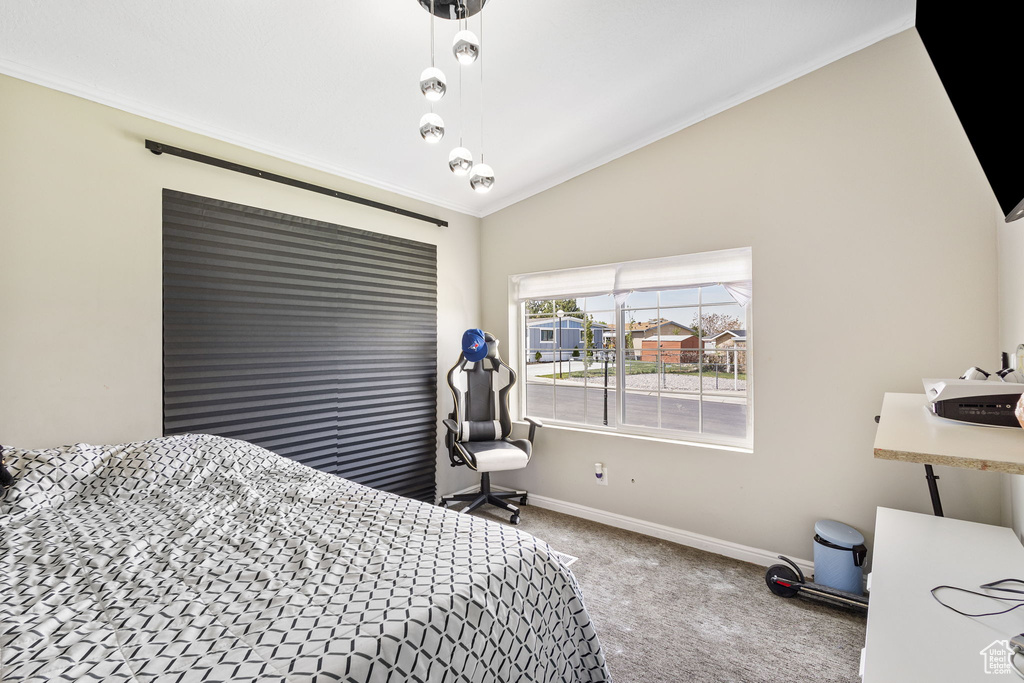 Bedroom with crown molding, carpet flooring, baseboards, and lofted ceiling