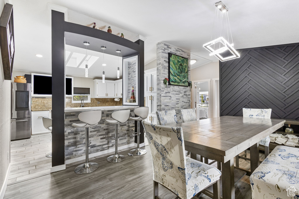 Dining room with an inviting chandelier and wood finished floors