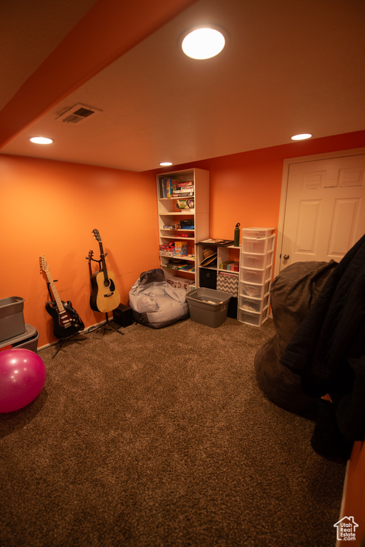 Interior space featuring carpet flooring, recessed lighting, and visible vents