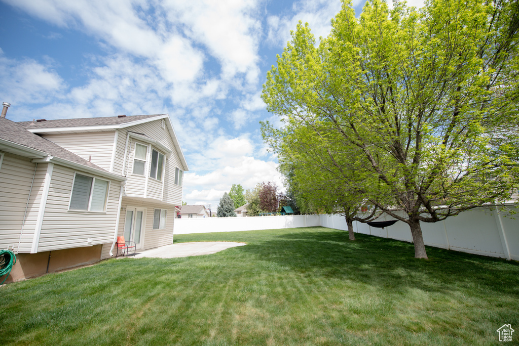 View of yard with a patio and a fenced backyard