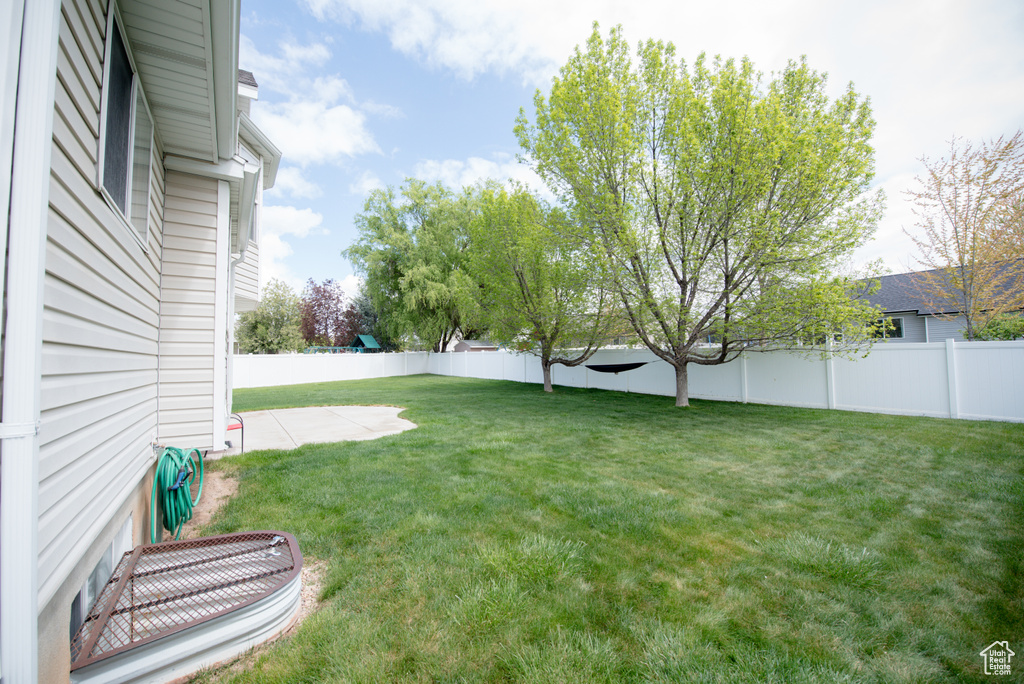 View of yard with a patio and a fenced backyard