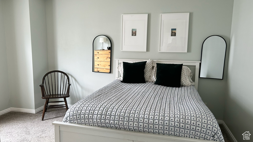Carpeted bedroom featuring baseboards and electric panel