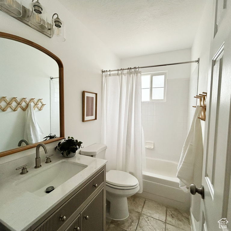 Full bath featuring toilet, shower / tub combo, and vanity