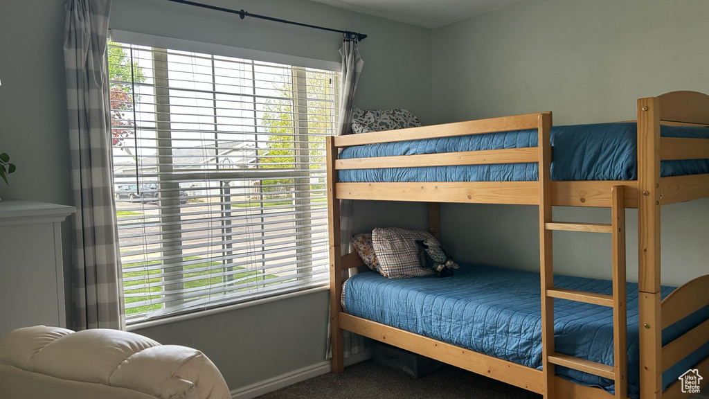 Bedroom with multiple windows, carpet flooring, and baseboards