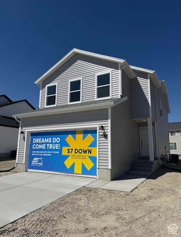 View of front of house with entry steps, an attached garage, concrete driveway, and central air condition unit