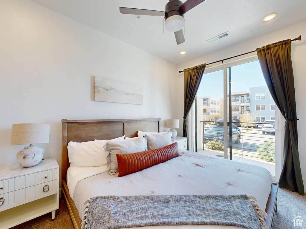 Bedroom with visible vents, access to exterior, ceiling fan, and carpet floors