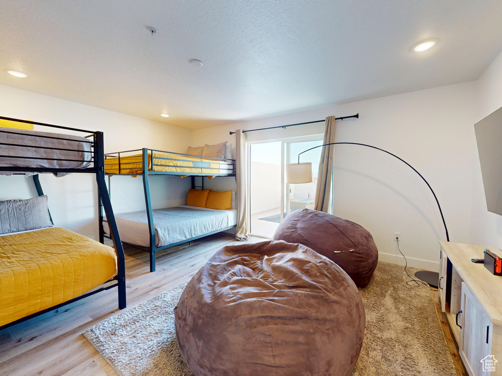 Bedroom with recessed lighting, light wood-style flooring, and baseboards