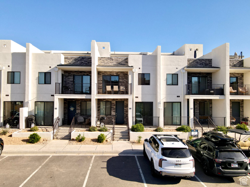 View of property featuring uncovered parking