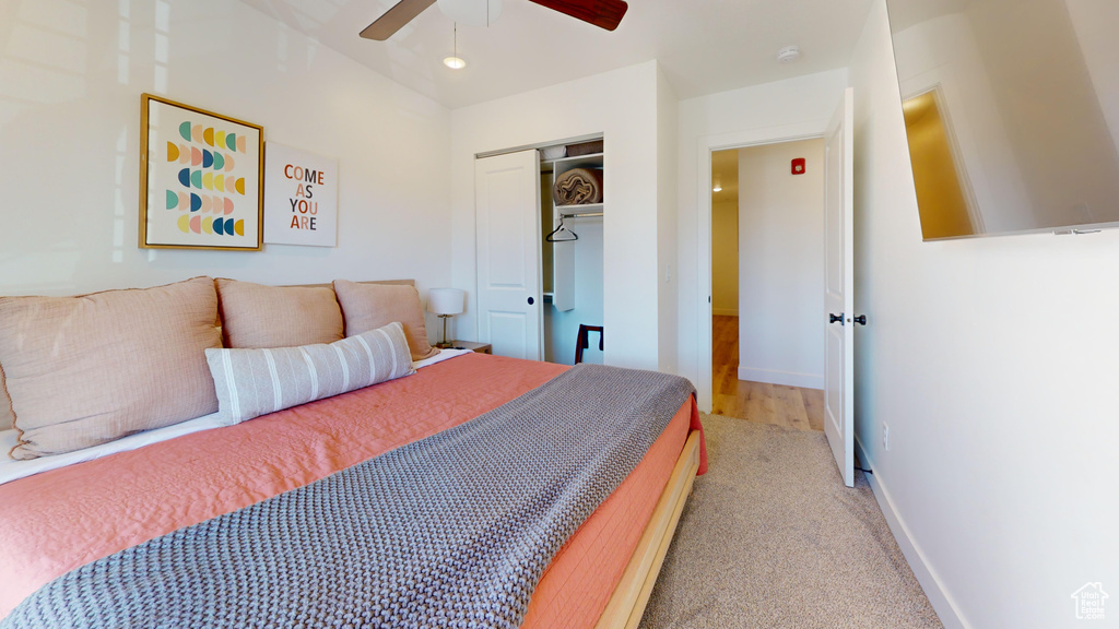 Bedroom featuring baseboards, a ceiling fan, carpet, and a closet