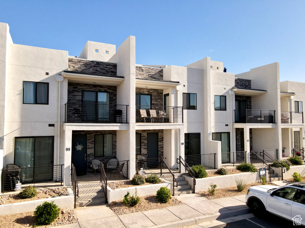 View of property featuring uncovered parking
