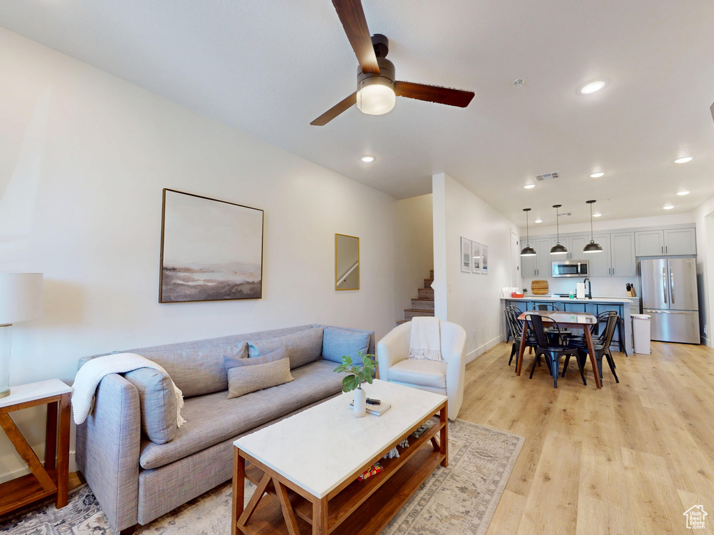 Living area featuring recessed lighting, a ceiling fan, and light wood-style flooring