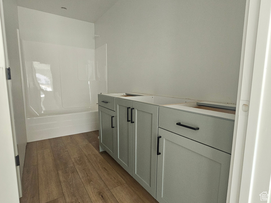 Full bathroom with wood finished floors and shower / bathing tub combination
