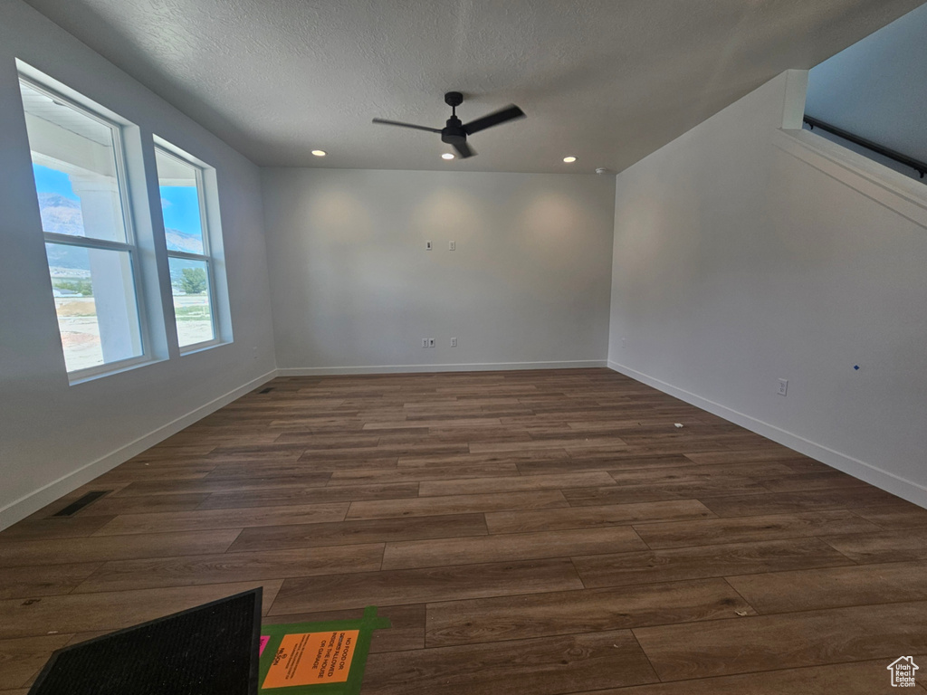 Unfurnished room with a ceiling fan, dark wood-style flooring, baseboards, recessed lighting, and a textured ceiling