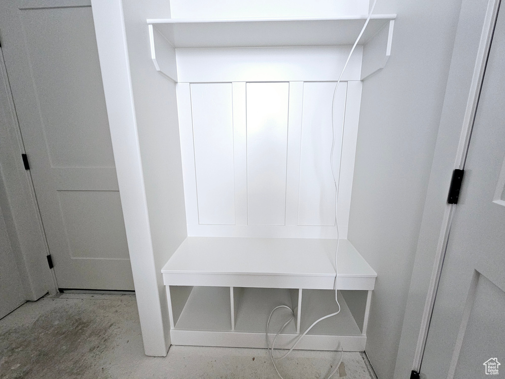 Mudroom with baseboards and unfinished concrete floors