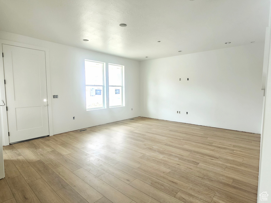 Empty room with light wood finished floors