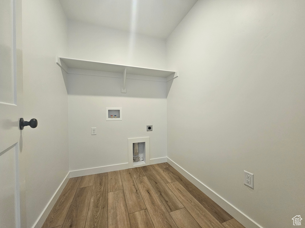 Washroom featuring wood finished floors, electric dryer hookup, washer hookup, and baseboards