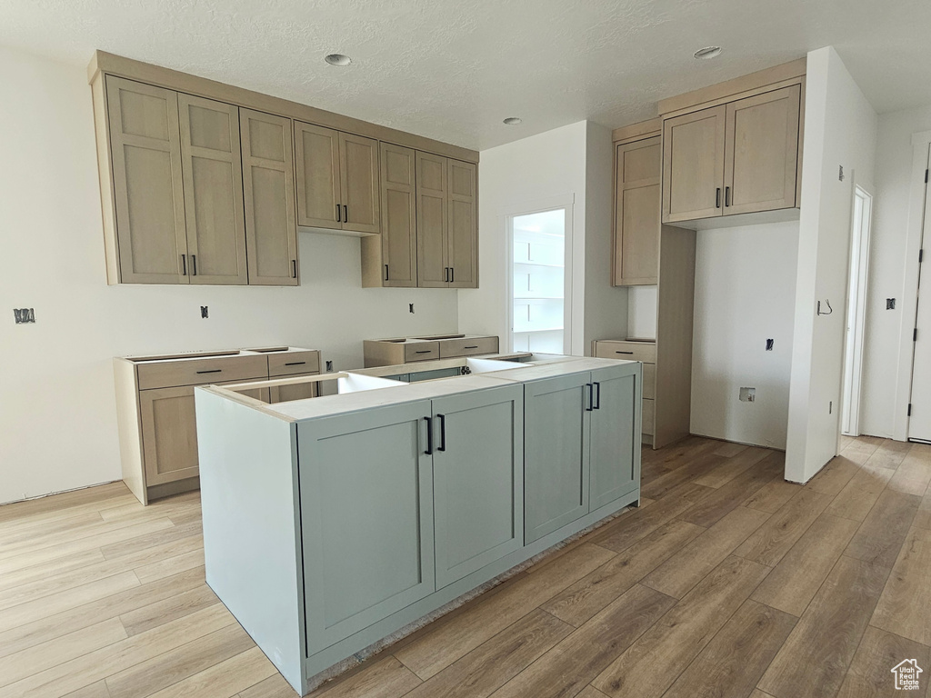 Kitchen with a center island, recessed lighting, and light wood-type flooring
