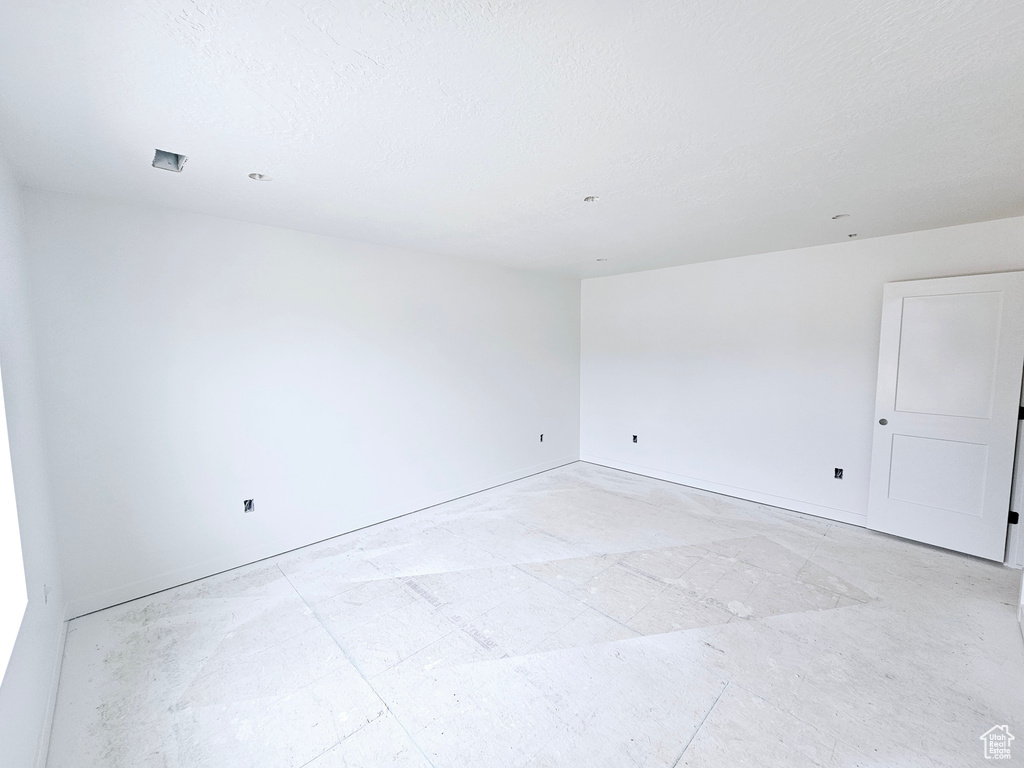 Spare room featuring baseboards
