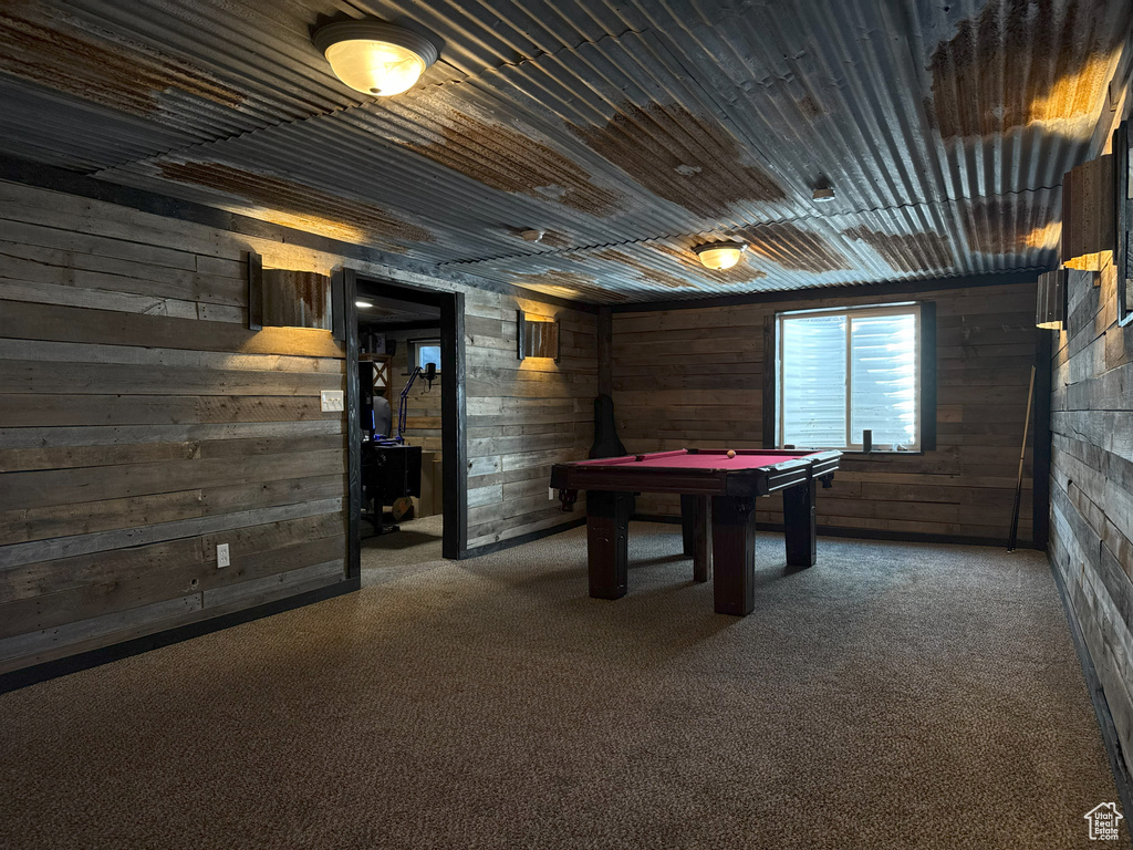 Game room with wood walls, carpet flooring, and pool table