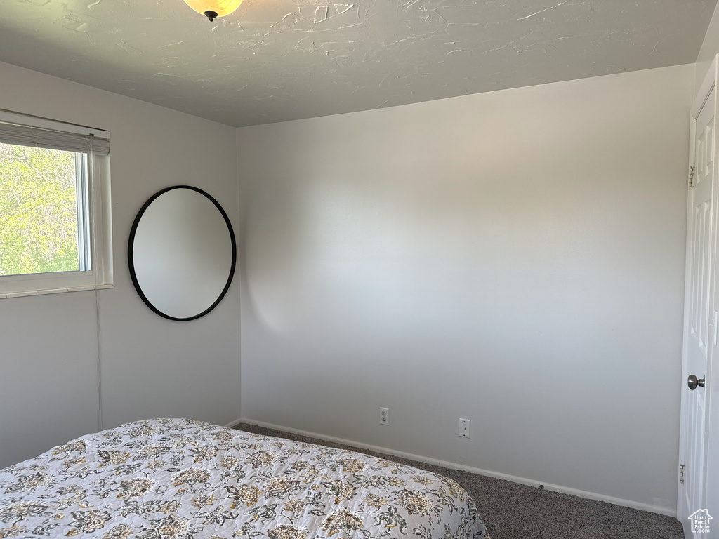 Carpeted bedroom featuring baseboards