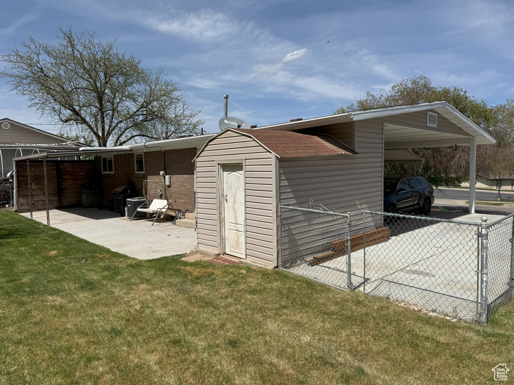 View of outbuilding with fence