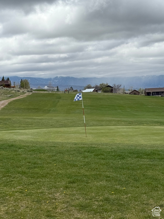 View of home\\\\\\\'s community with a mountain view, golf course view, and a lawn