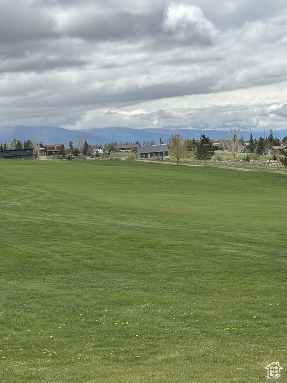 View of home\\\\\\\'s community with a mountain view, golf course view, and a lawn