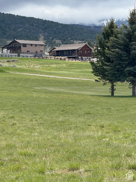 View of home\\\\\\\'s community featuring a mountain view and a lawn