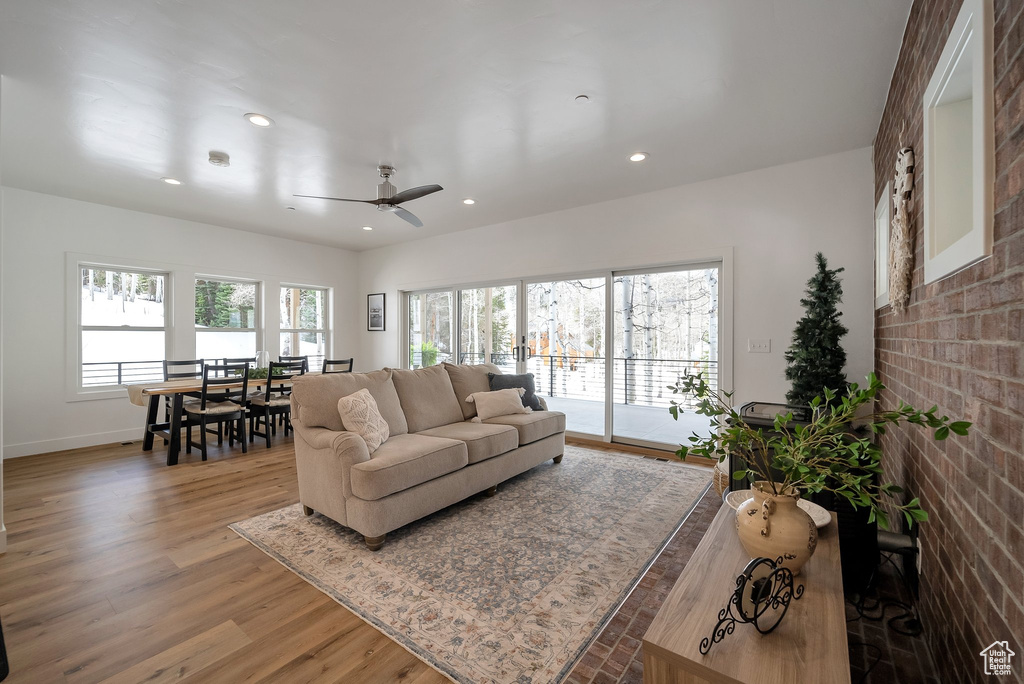Living area featuring baseboards, recessed lighting, wood finished floors, and a ceiling fan