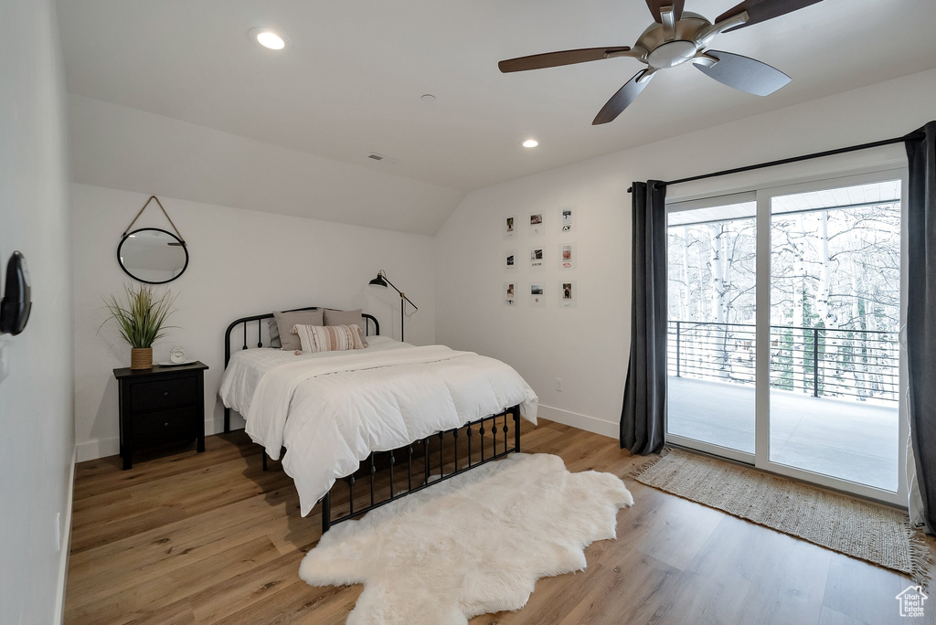 Bedroom featuring recessed lighting, light wood-style flooring, access to exterior, baseboards, and lofted ceiling