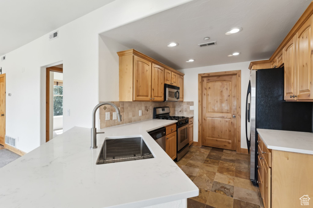 Kitchen featuring visible vents, stainless steel appliances, and a sink