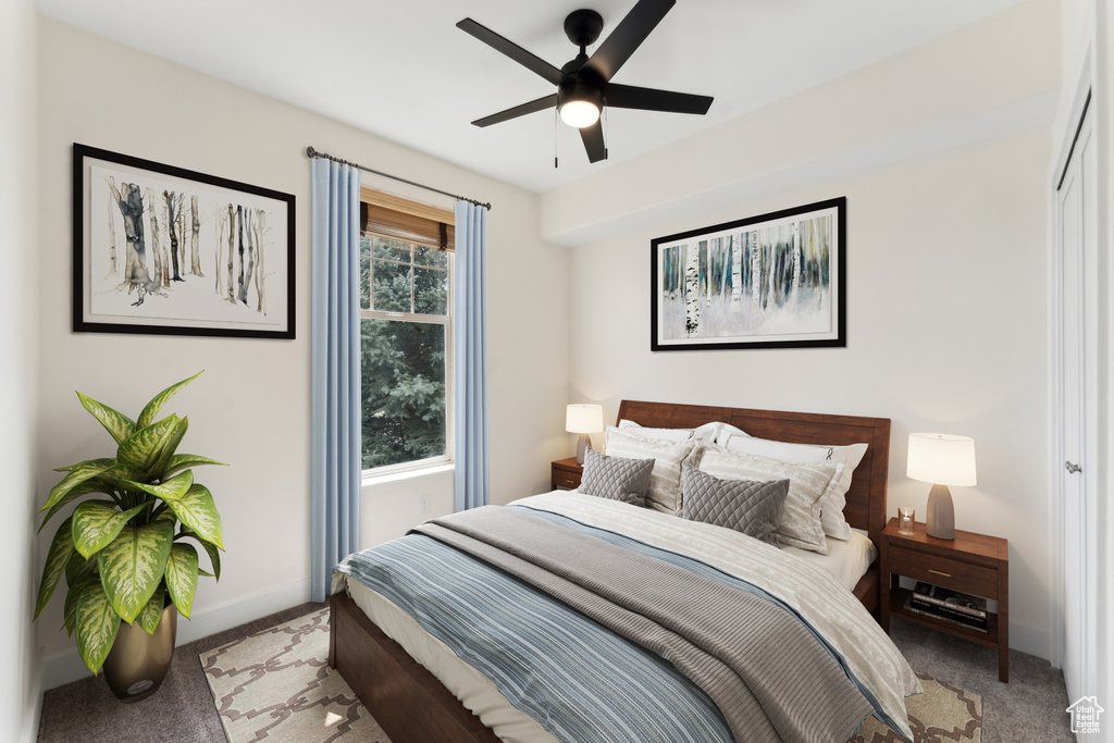 Bedroom featuring a ceiling fan, light colored carpet, and baseboards
