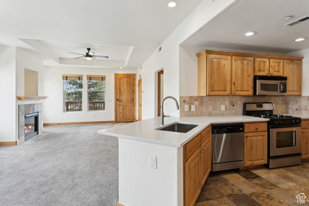 Kitchen featuring a sink, ceiling fan, visible vents, appliances with stainless steel finishes, and open floor plan