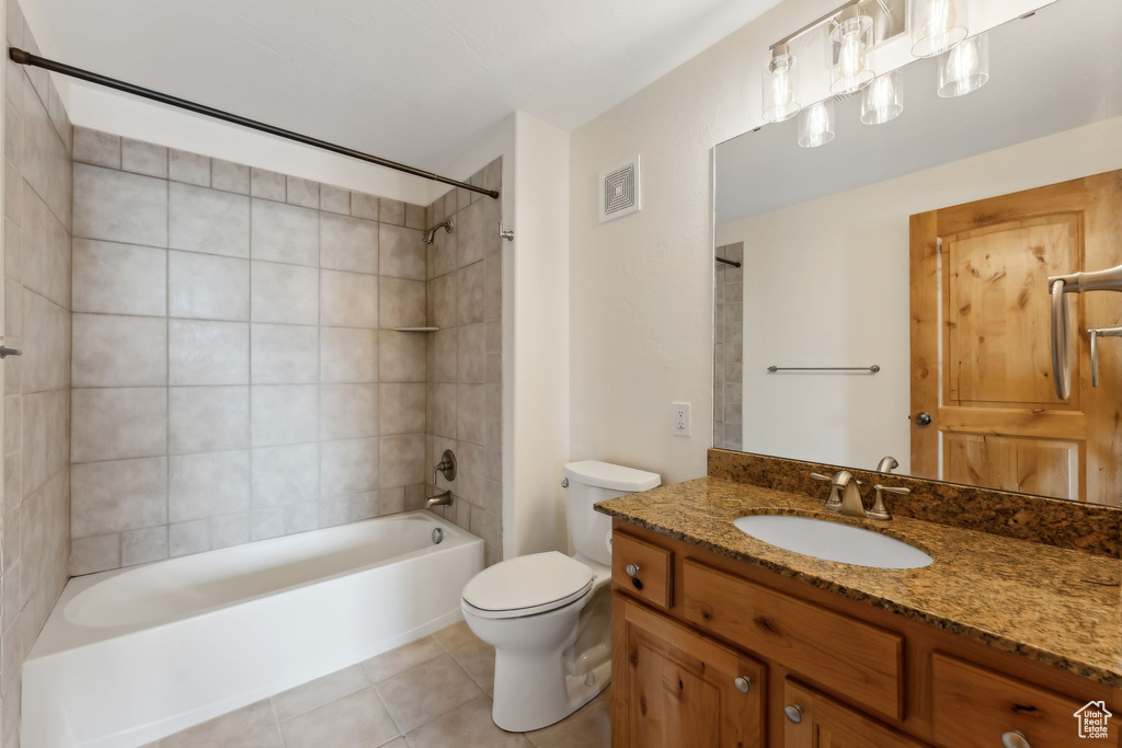 Full bath featuring vanity, tile patterned floors, toilet, visible vents, and  shower combination