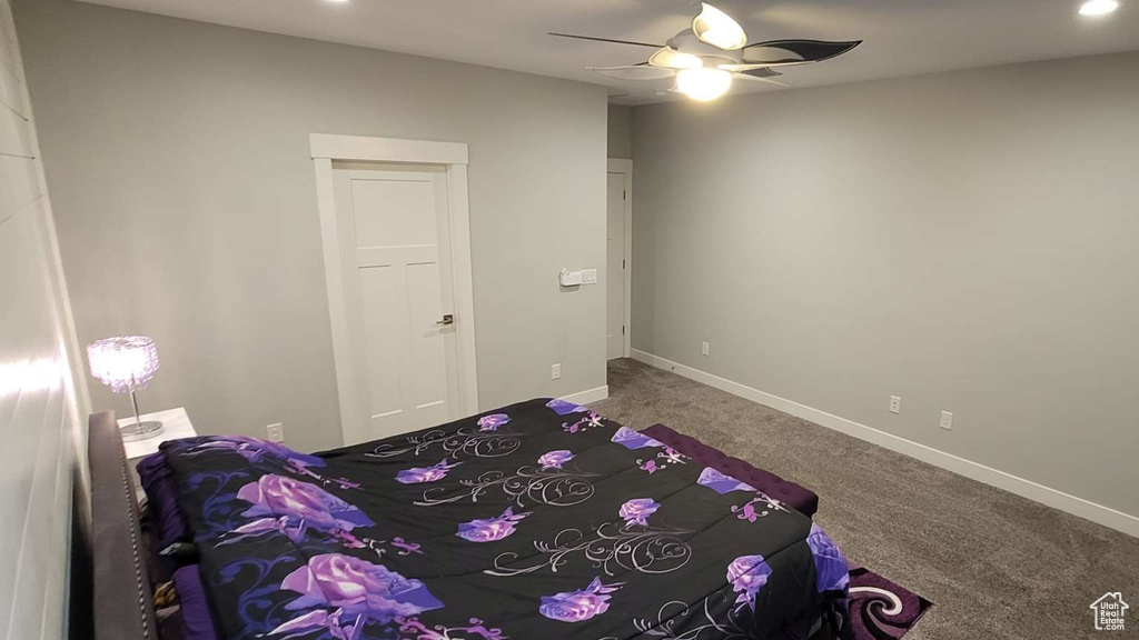 Carpeted bedroom featuring baseboards, recessed lighting, and ceiling fan